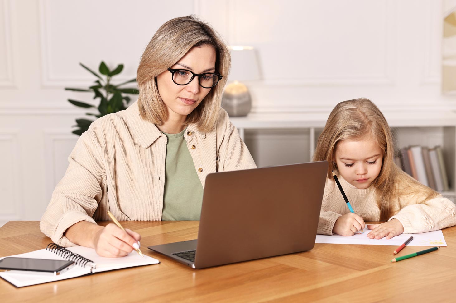 Female bookkeeper working from home finding balance between family and business responsibilities with calm focus.